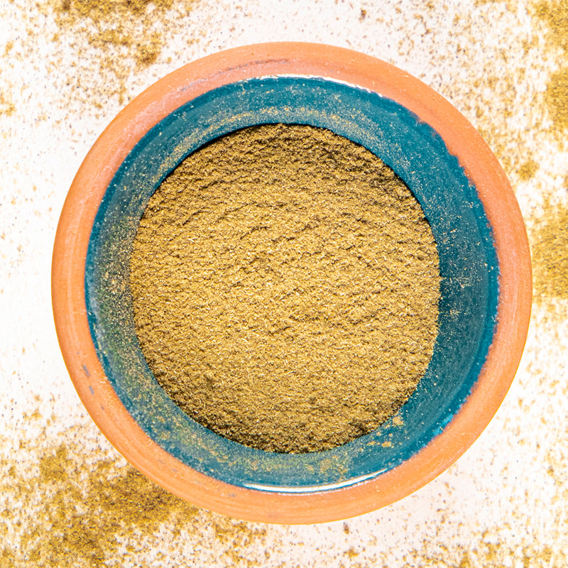 Motherwort herb powder in blue clay bowl with white background and herb surrounding.