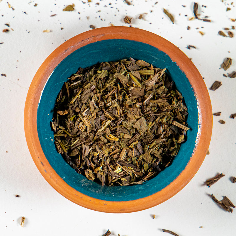 Plantain Leaf herb in blue clay bowl with white background and herb surrounding.